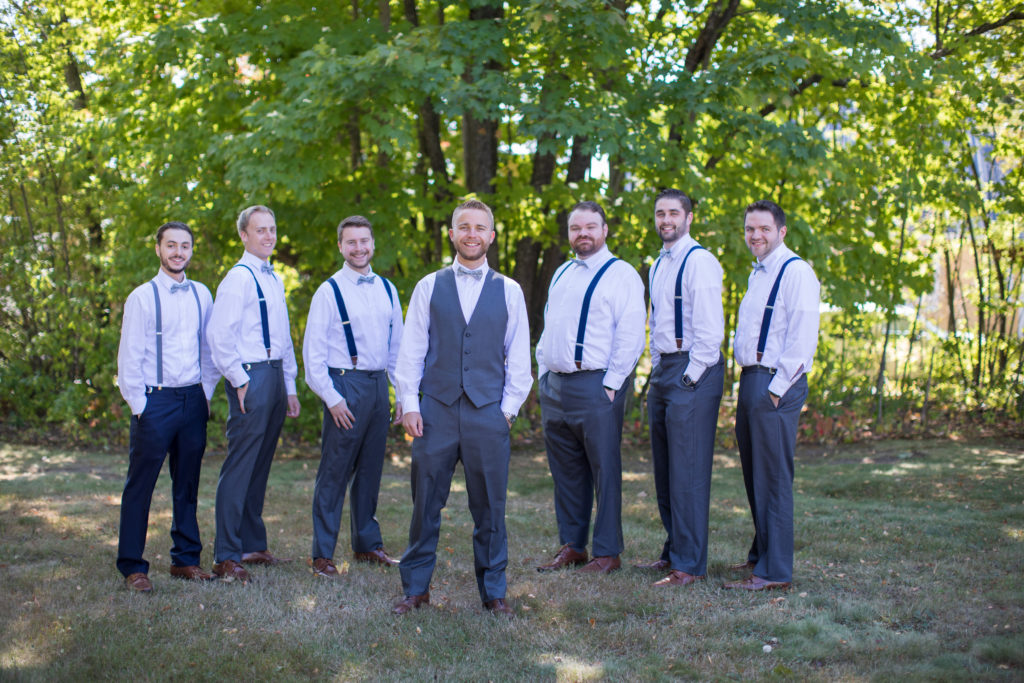 groom with his groomsmen outside at fall wedding