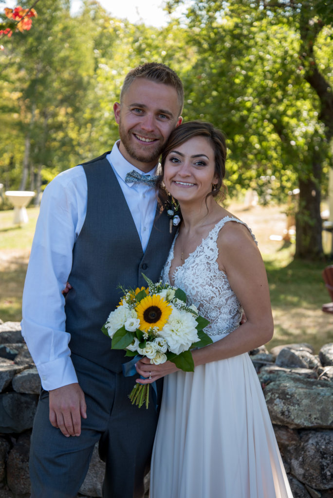 bride and groom smiling at the camera at a fall wedding in NH 