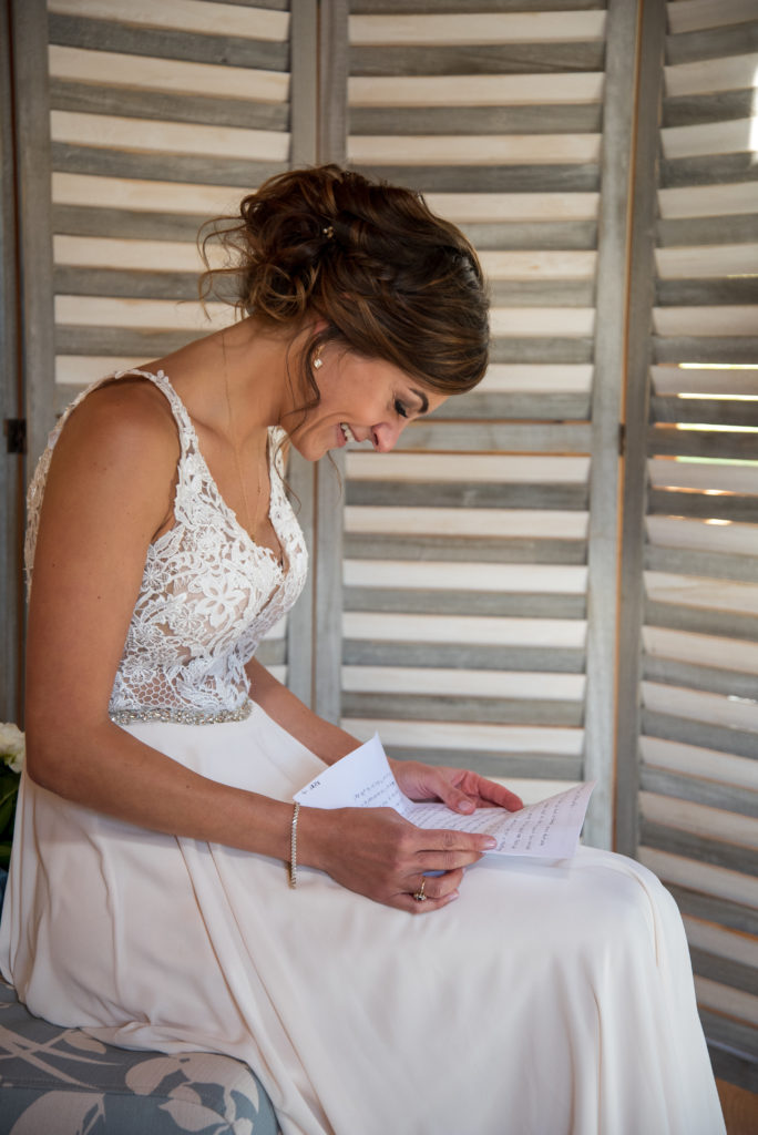 bride reading her letter from the groom before the ceremony
