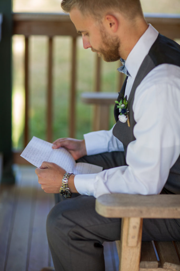 groom reading a letter from his bride before the ceremony