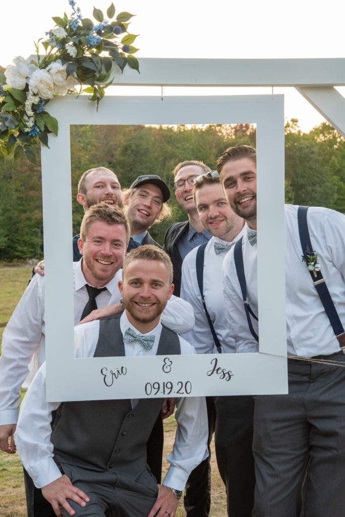 groom and his friends in a photo booth