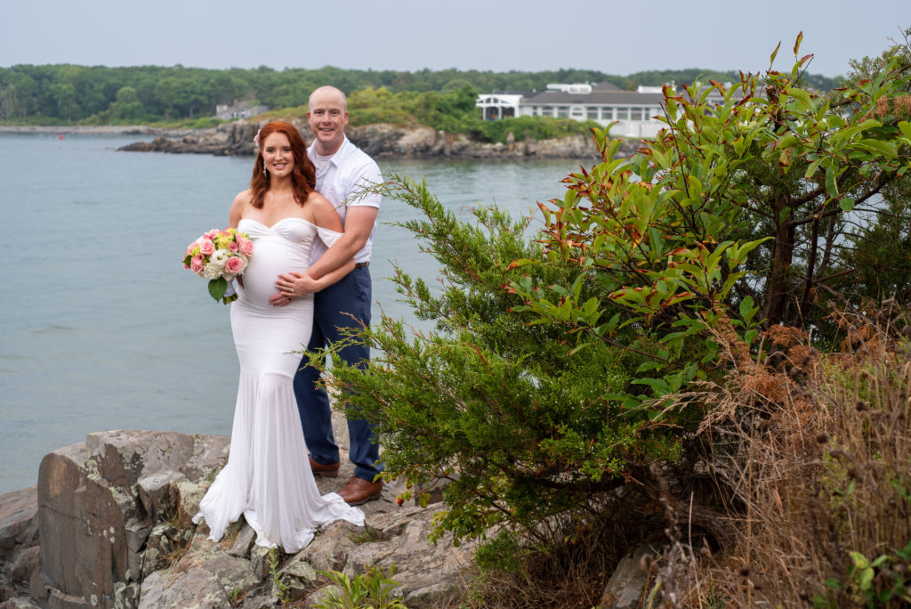 bride and groom posing on rocks in front of the ocean at York Harbor Inn elopement 