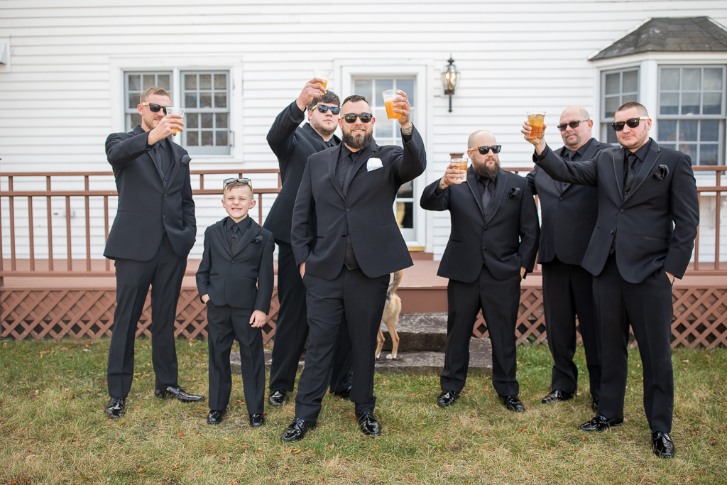 groom and his guys cheering their beers