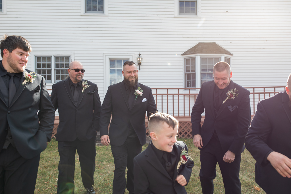 groom and his guys walking and smiling at each other