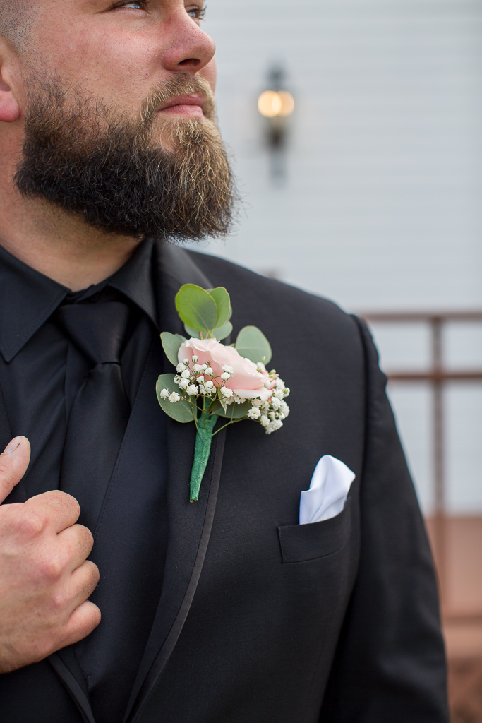 close up of groom's beard, boutonniere and tie