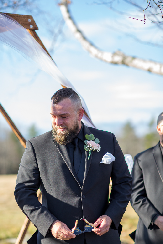 Groom trying to hold it together as bride walks down the aisle