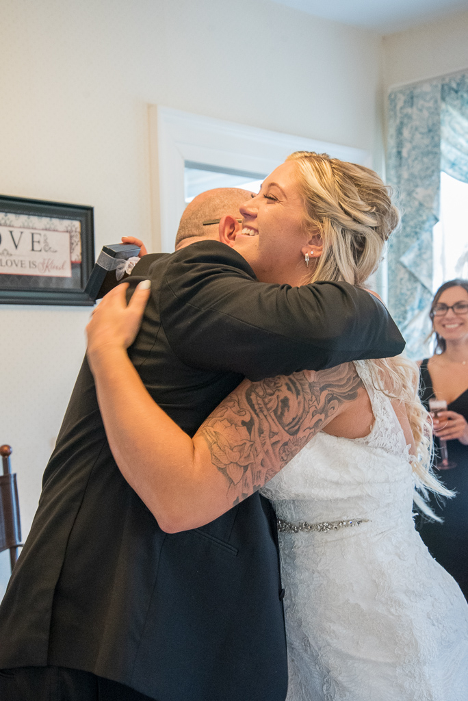 bride hugging her dad after giving him a gift