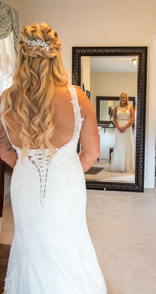 Bride looking at herself in the mirror