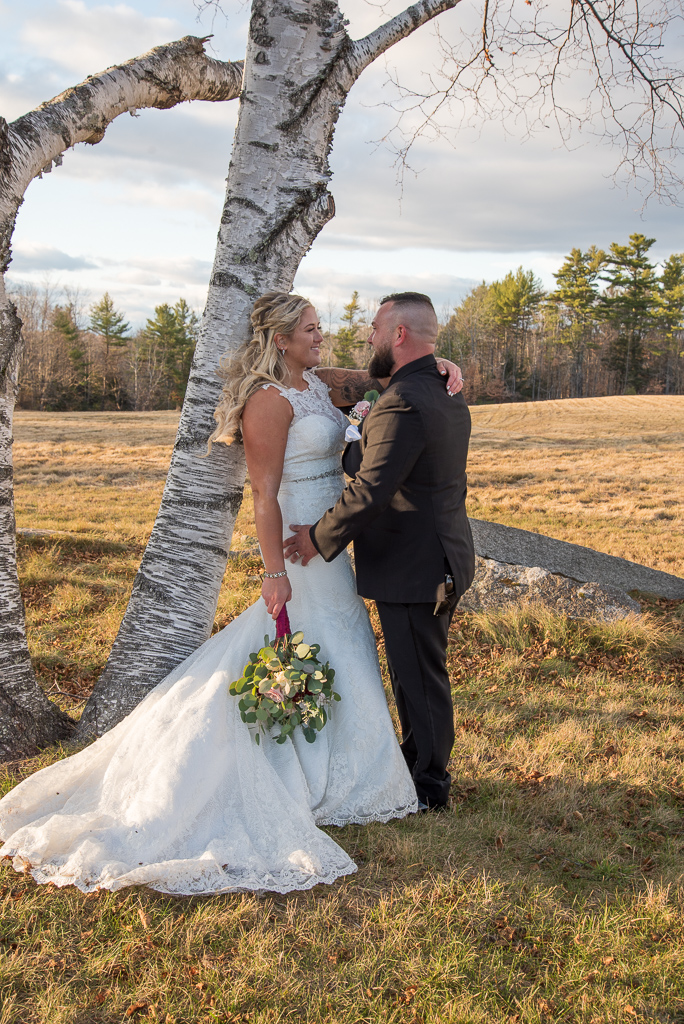 bride and groom leaning against white birch tree