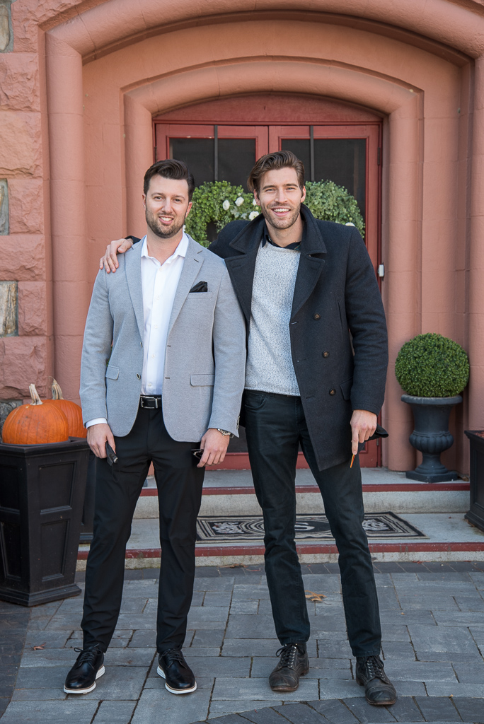 two grooms standing in front of searles castle at bridal shower