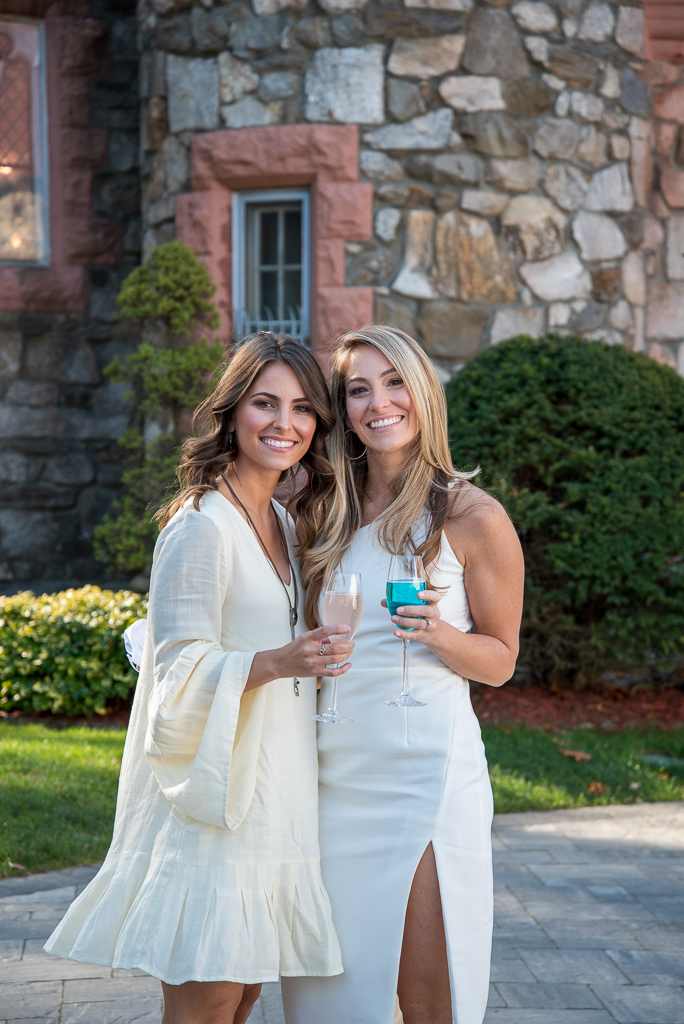 two brides who are sisters holding their special colored drinks