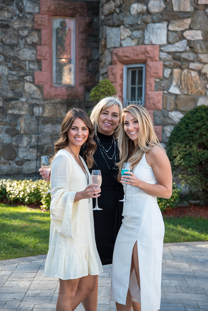 two brides with their mom who planned their bridal shower