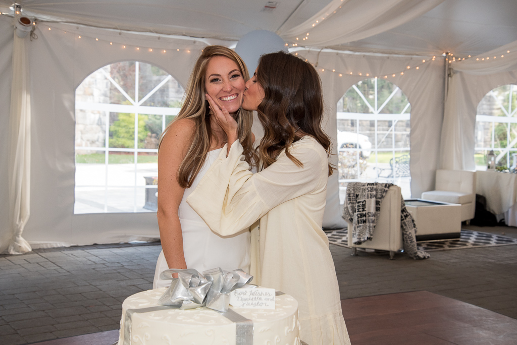 sister kissing her sister on the cheek at bridal shower