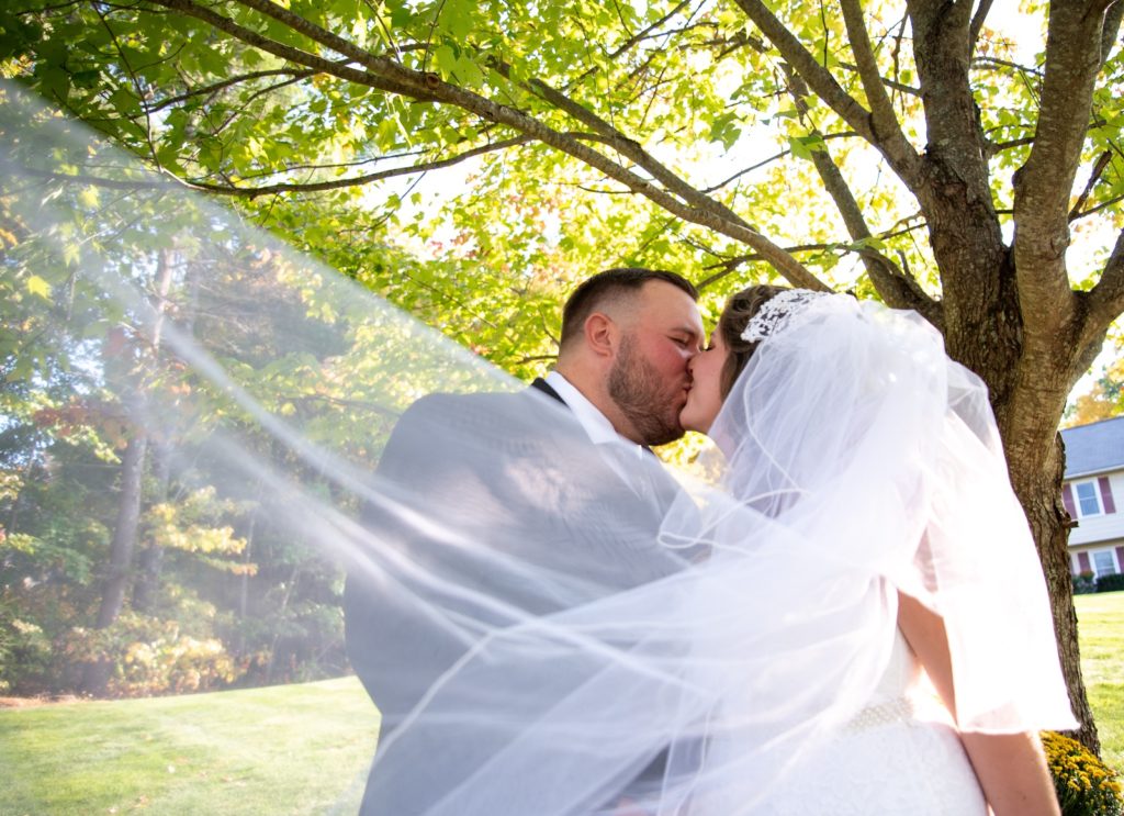 2020 wedding couple kissing behind the veil