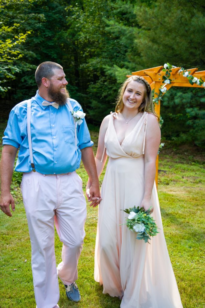 2020 backyard wedding bride and groom holding hands