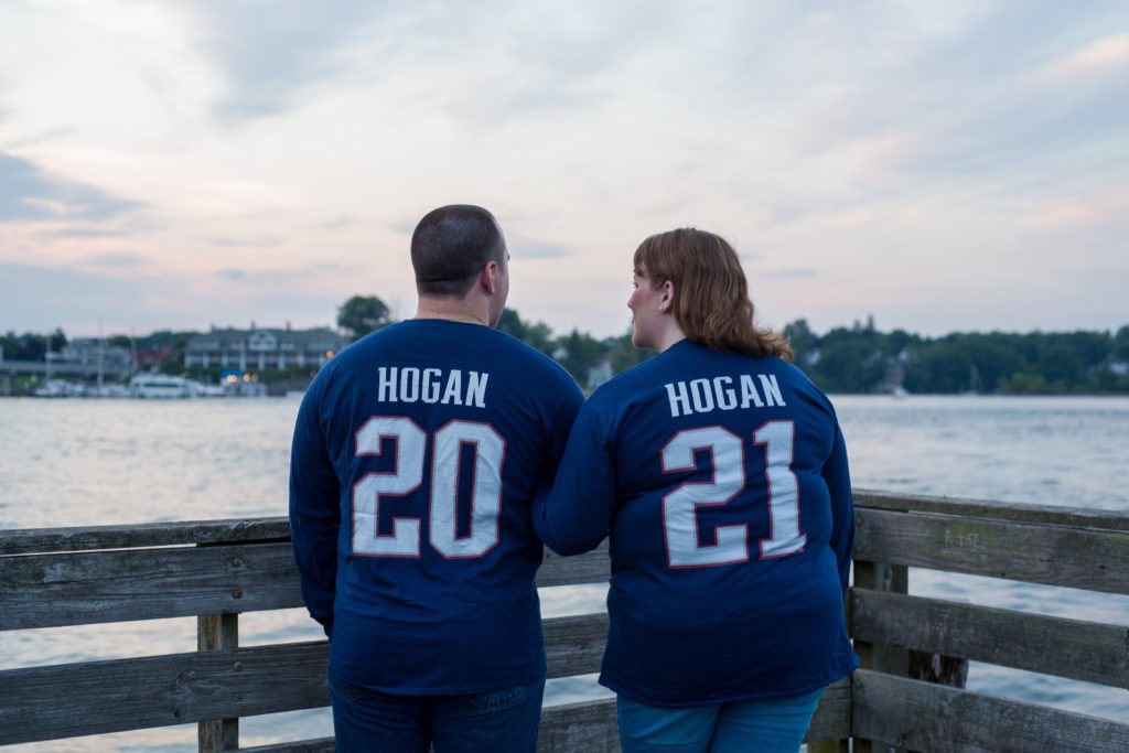 Kristen and Danny with their football shirts with their last name and wedding year on the back