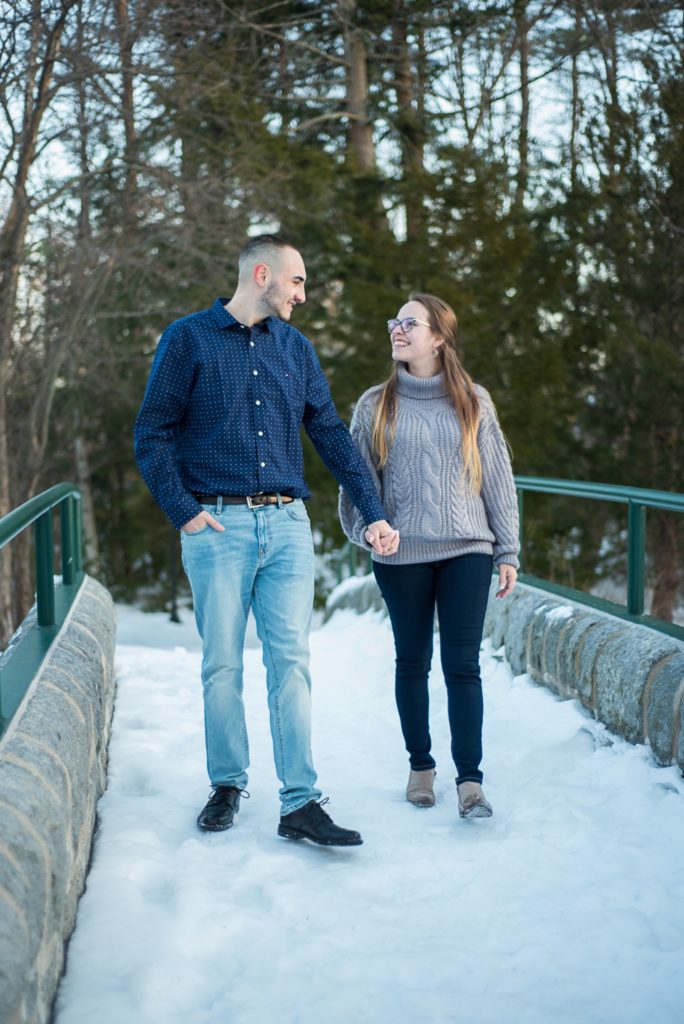 2020 engagement winter session Jorge and Brianna walking across a snowy bridge