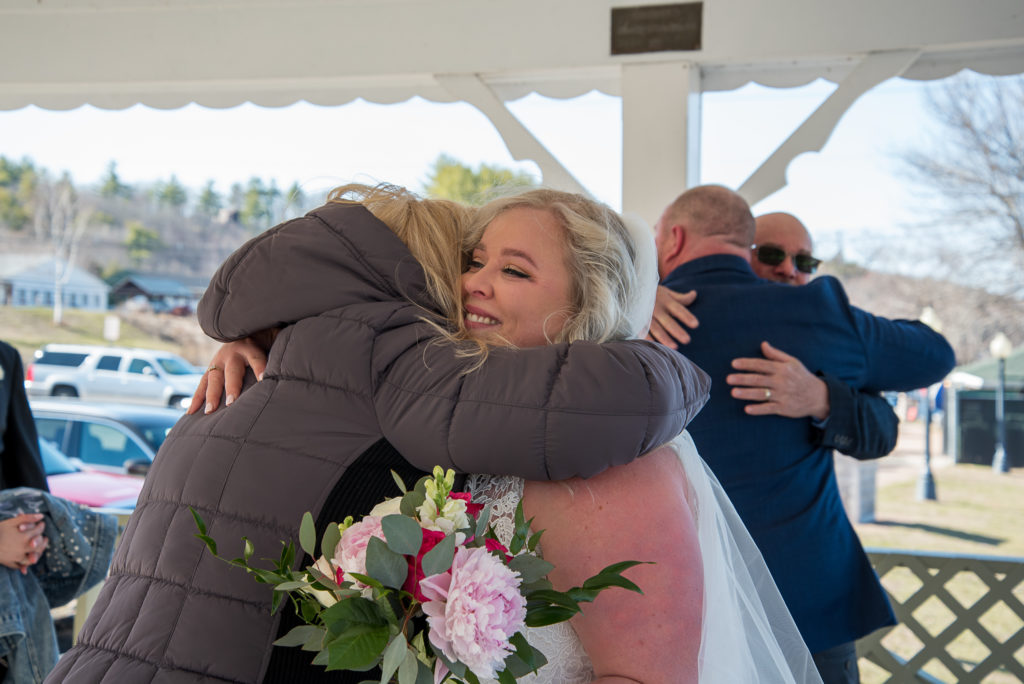 mother of groom hugging bride