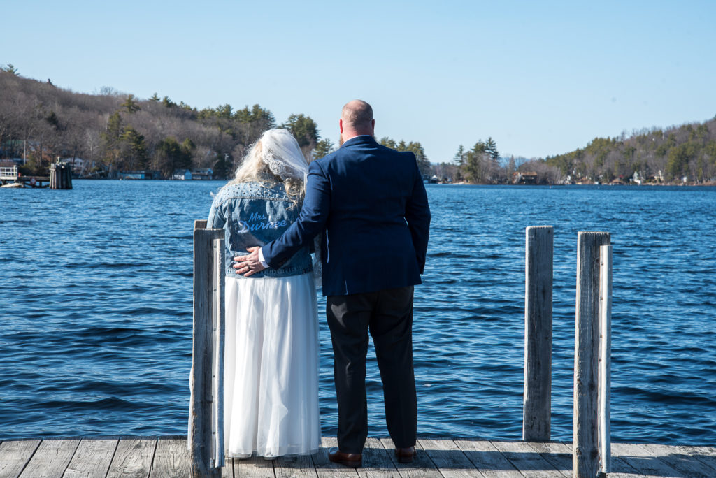 bride and groom facing the lake after their elopment
