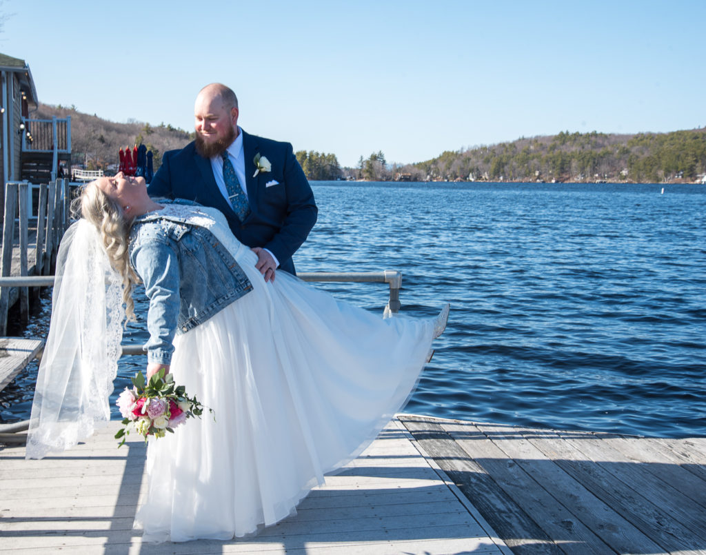 groom dipping his bride on the docks after their alton bay elopement
