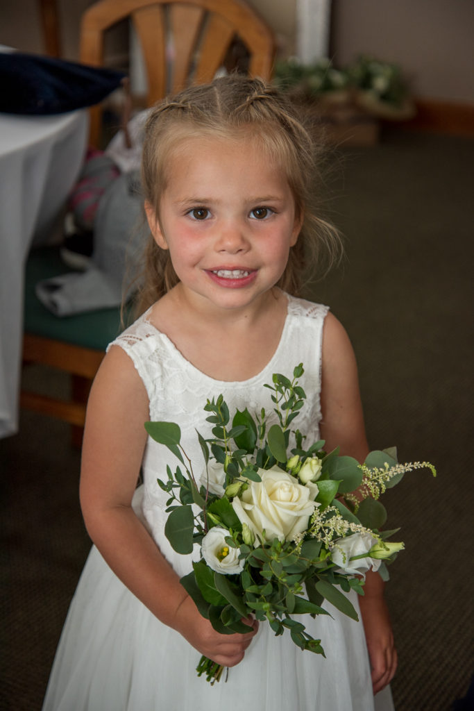 beautiful little flower girl with her flowers