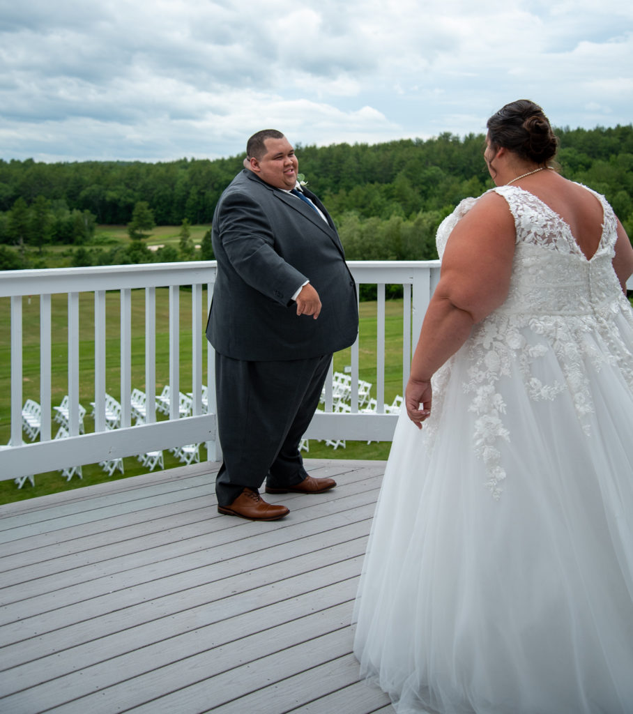 groom turning around at the first look at a summer loving wedding to see his bride for the first time