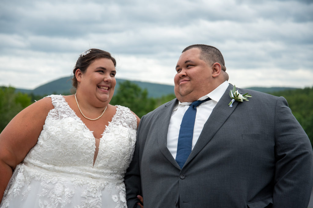 bride and groom smiling at each other at a summer loving wedding