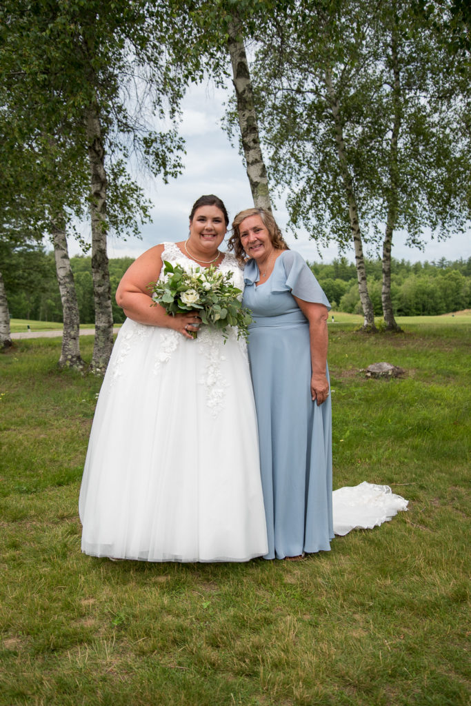 bride and her mom posing on the golf course
