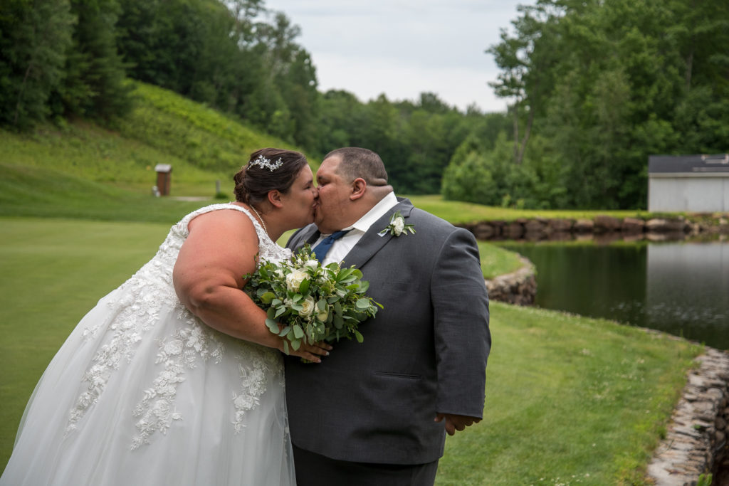 bride and groom posing on the golf course at Stonebridge Country Club at a summer loving wedding