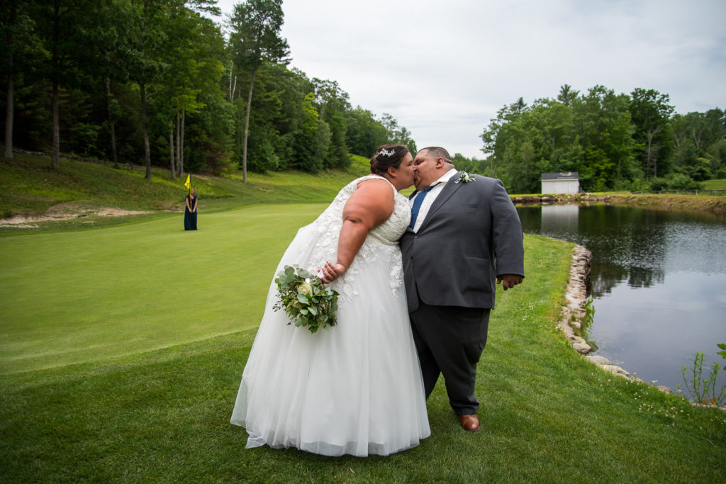 bride and groom posing on the golf course at Stonebridge Country Club at a summer loving wedding