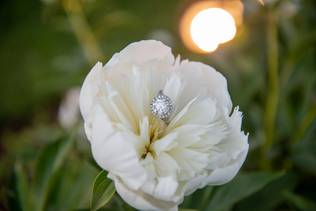engagement ring inside of a white flower 