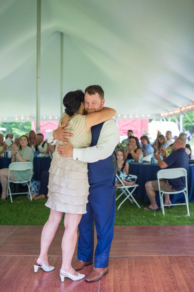 groom dancing with his mother at backyard summer wedding