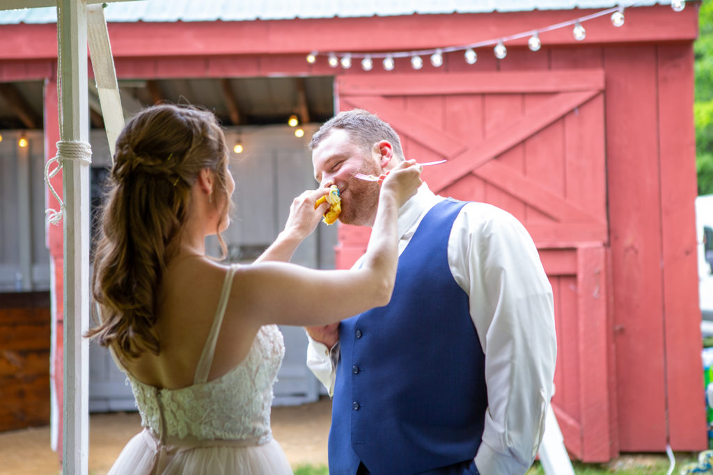 bride feeding her groom a cupcake
