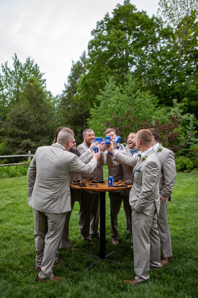groom and his groomsmen cheering with beer
