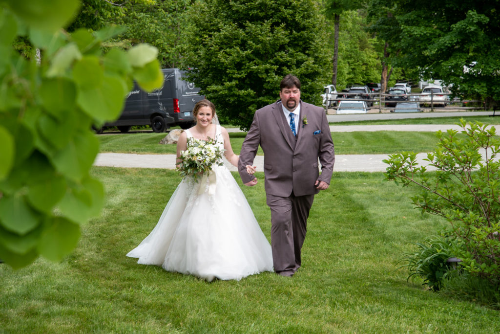 bride with her dad walking down the aisle