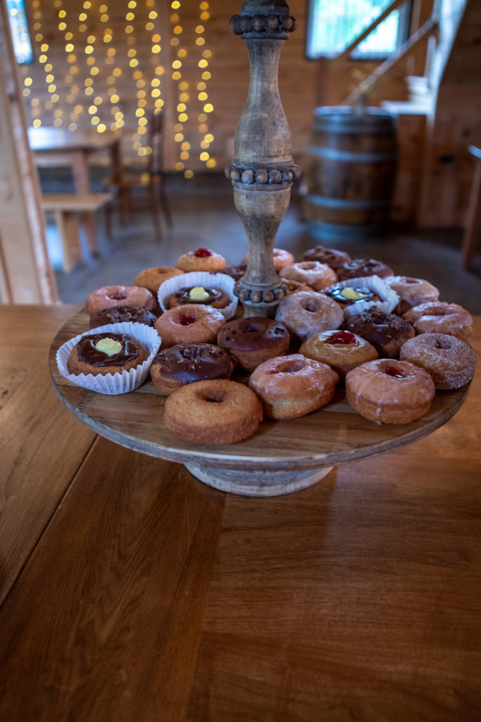 donuts on a cake stand during a rustic elegant wedding 