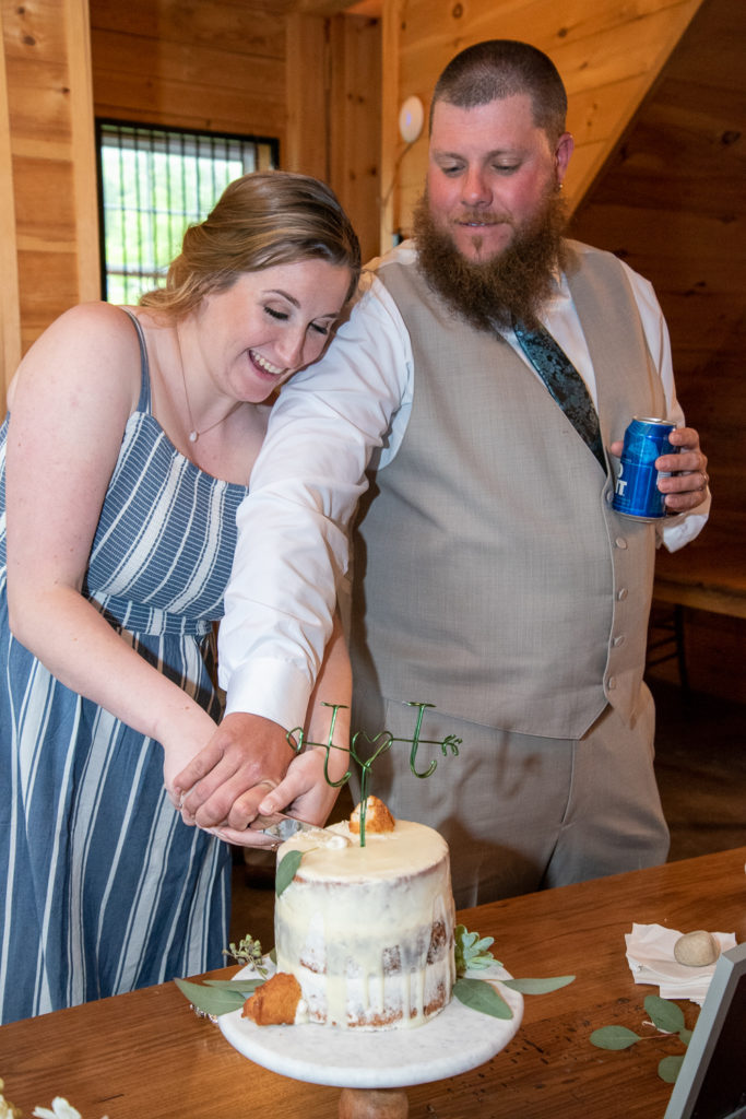 bride and groom cutting their cake 