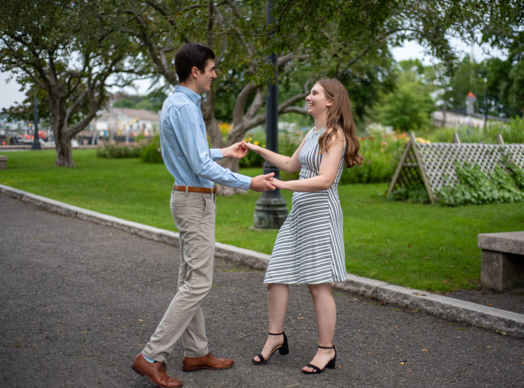 bride and groom to be dancing at prescott park engagement session