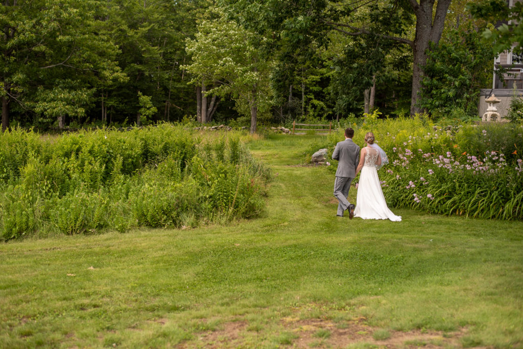 bride and groom walking into a garden after the ceremony