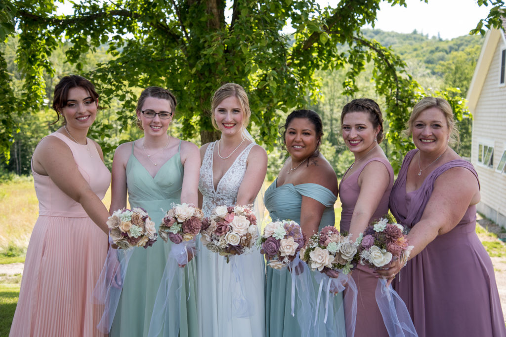 bride and her bridesmaids holding out their flowers