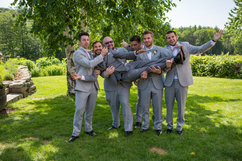 groomsmen holding up the groom at NH summer barn wedding 