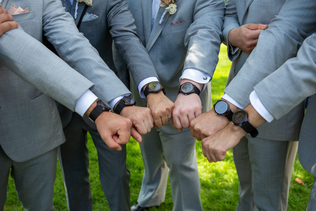 groom and groomsmen showing off their watches