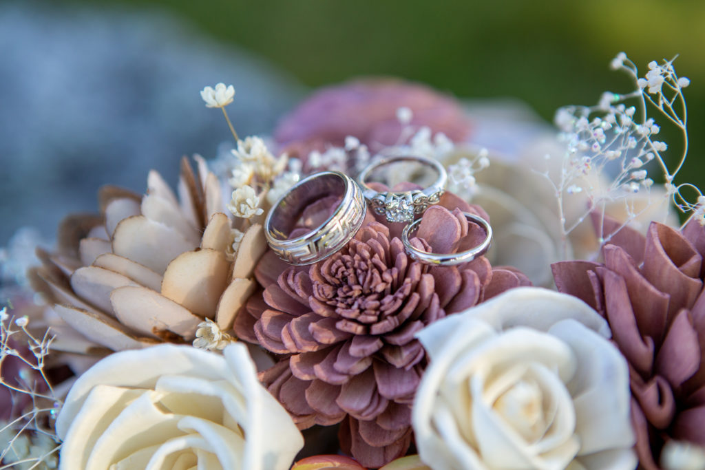 wedding rings on wooden flower bouquet