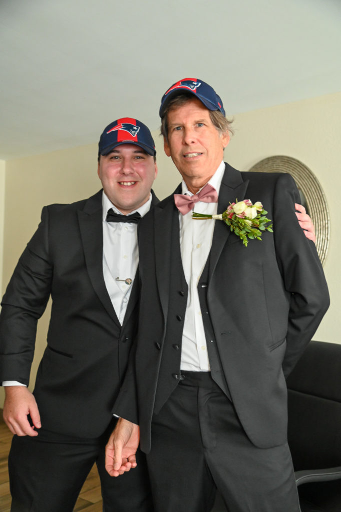 groom and his dad with their baseball hats at The Oaks Somersworth NH wedding