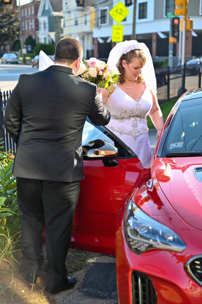 bride getting into sports car at The Oaks Somersworth NH wedding