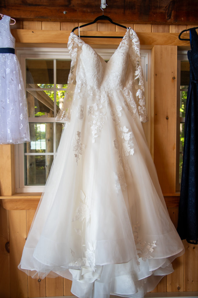 dress hanging up in the cabin at the wedding at the lake