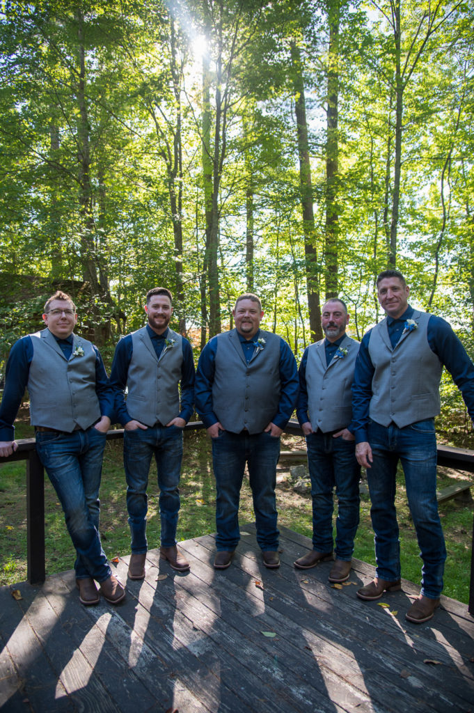 groom and groomsmen at wedding at the lake