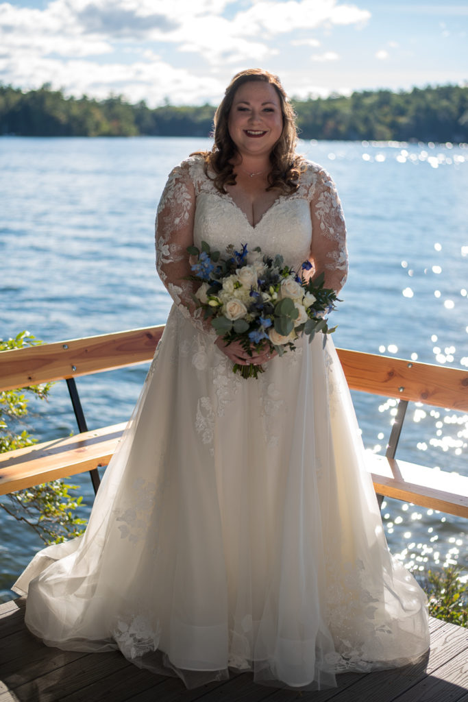 bride standing with lake in the background at wedding at the lake