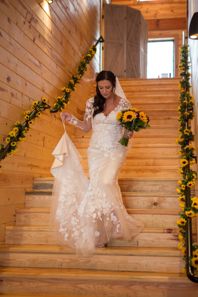 bride walking down the stairs at fall wedding at the barn at bull meadow