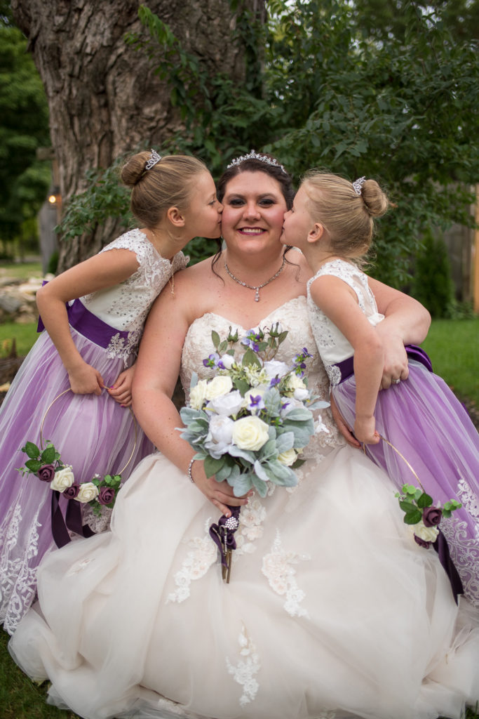 Derek & Tiffany (bride and groom) wedding - Tiffany with her flower girls kissing her on the cheek